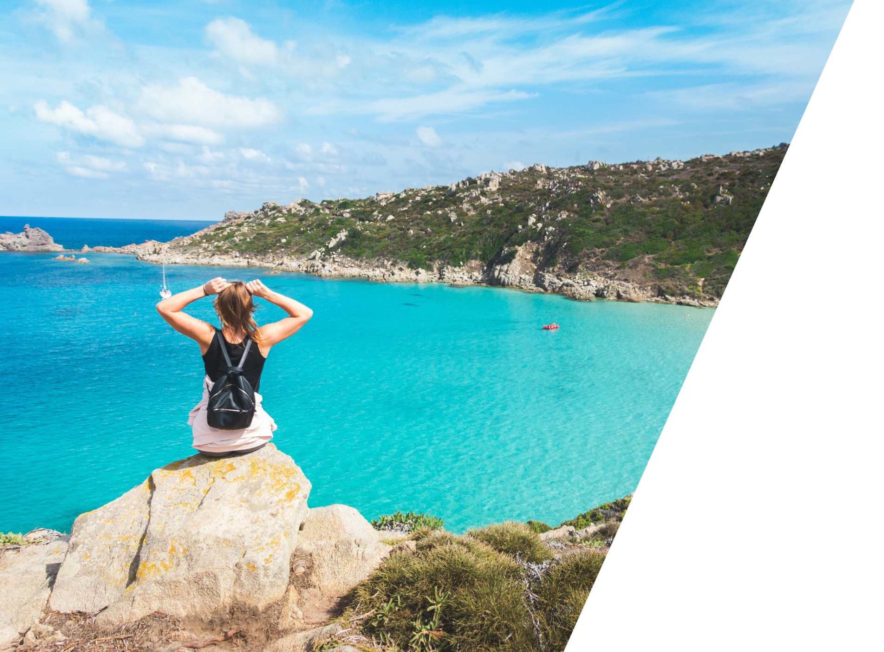 Female student with a backpack looking out over turquoise sea from a cliff.