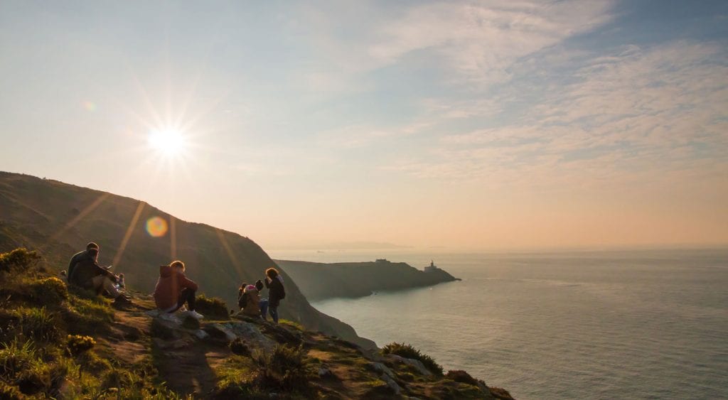 Cliffs by the sea in Ireland under bright sunshine.
