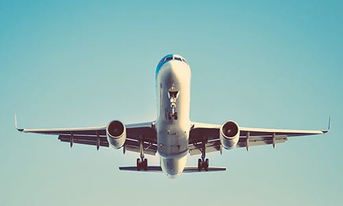Flying white airplane