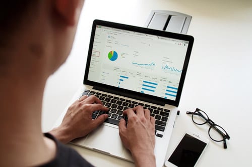 man is typing on the laptop