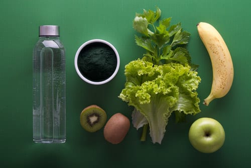 nutritious food, cup of coffee and a plastic bottle and green background