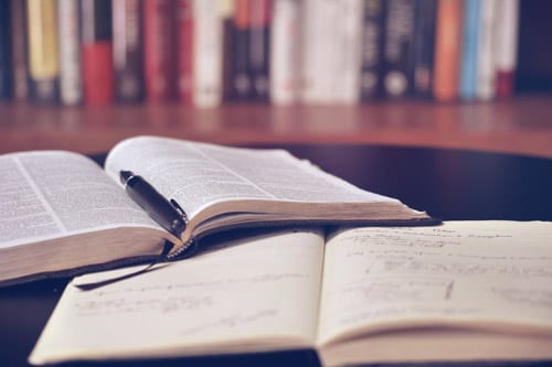 books lying open on top of a table