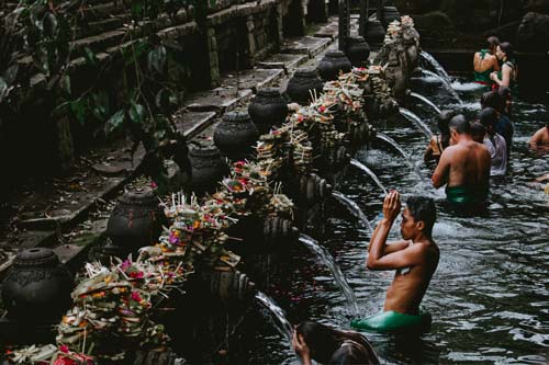 people performing rituals with water