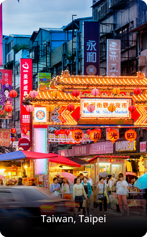 Bustling night market in Taipei, Taiwan, filled with colorful lights, food stalls, and crowds enjoying the lively evening scene.