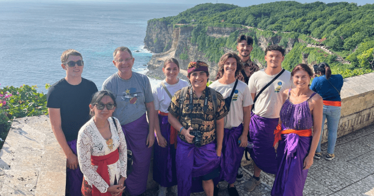 Participants of the faculty-led program posing for a group photo at the cliffs in Bali.